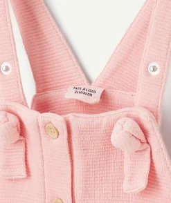 Salopette bébé fille rose en nid d'abeilles avec noeuds