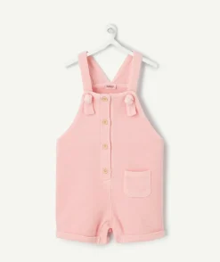 Salopette bébé fille rose en nid d'abeilles avec noeuds