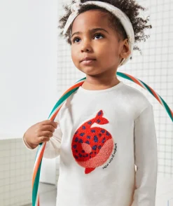 T-shirt bébé fille en coton bio écru avec baleine en bouclette