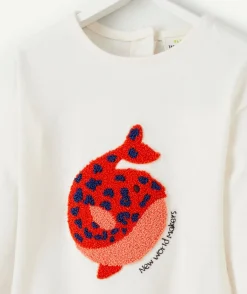 T-shirt bébé fille en coton bio écru avec baleine en bouclette